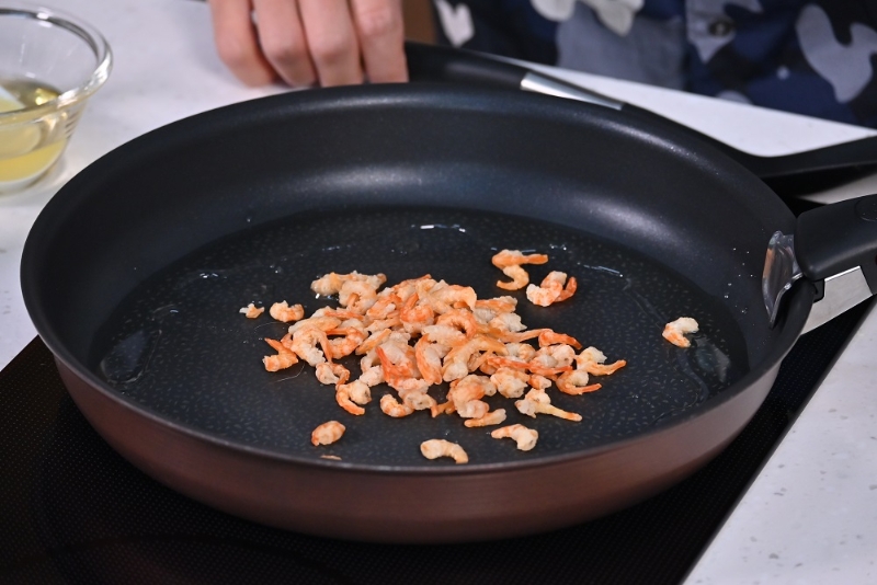 4. 起油鑊，炒香蝦米。Heat oil in a wok and fry dried shrimps until fragrant.